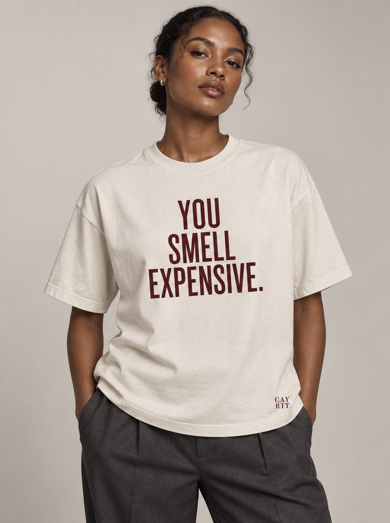 Studio render: a woman in a bone T-shirt reading You smell expensive.