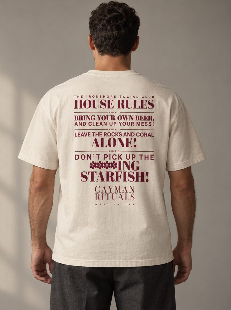 Studio render: the back of the shirt, printed with the Ironshore Social Club house rules and the Cayman Rituals signature.